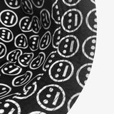 Close-up of underside of the rim on the black side of a reversible bucket hat with white Hieroglyphics logo on repeat. 