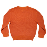 The backside of a heavy cotton knit sweater in autumn orange.