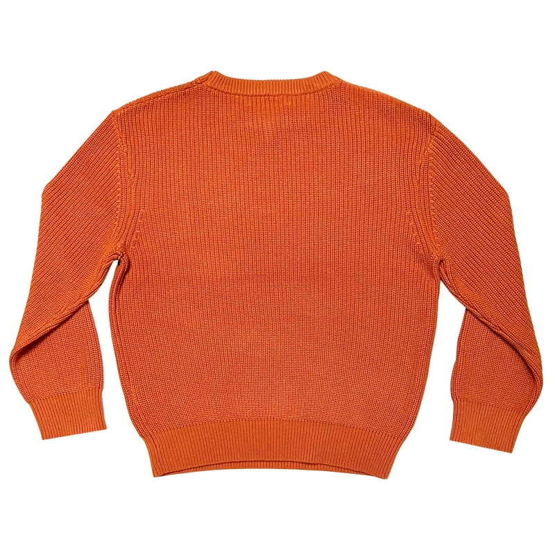 The backside of a heavy cotton knit sweater in autumn orange.