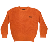 Heavy cotton knit sweater with embroidered Oaklandish wordmark woven label patch on front left chest in autumn orange.