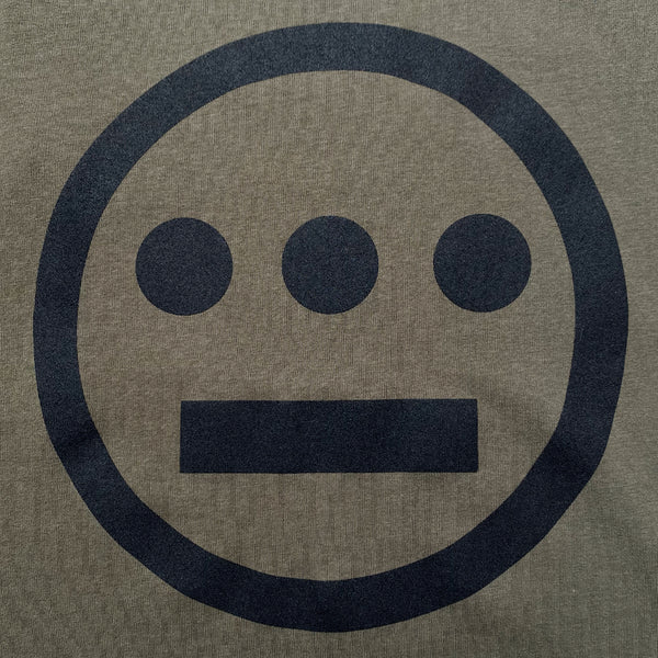 Close-up of black Hieroglyphics hip hop logo on the chest of an army green tank top.