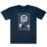 The front side of a navy t-shirt with a graphic of Hiero logo spotlight signal in Oakland’s night sky above buildings.