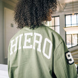 Image of female model wearing Army Hiero cadet jacket with Wordmark Hiero appliqué on back.