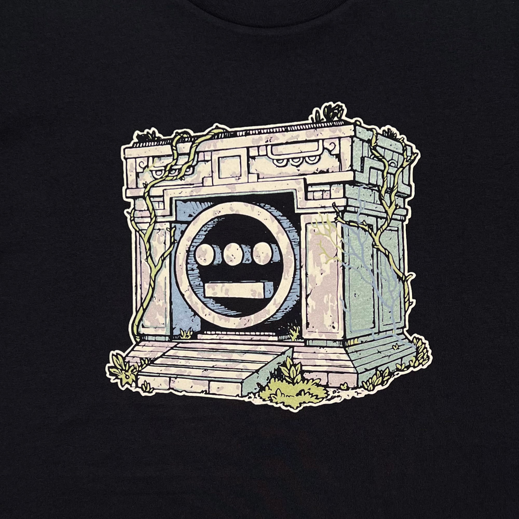 Detailed close of a graphic illustration of a crypt with the Hiero hip-hop logo in the center on a black t-shirt.