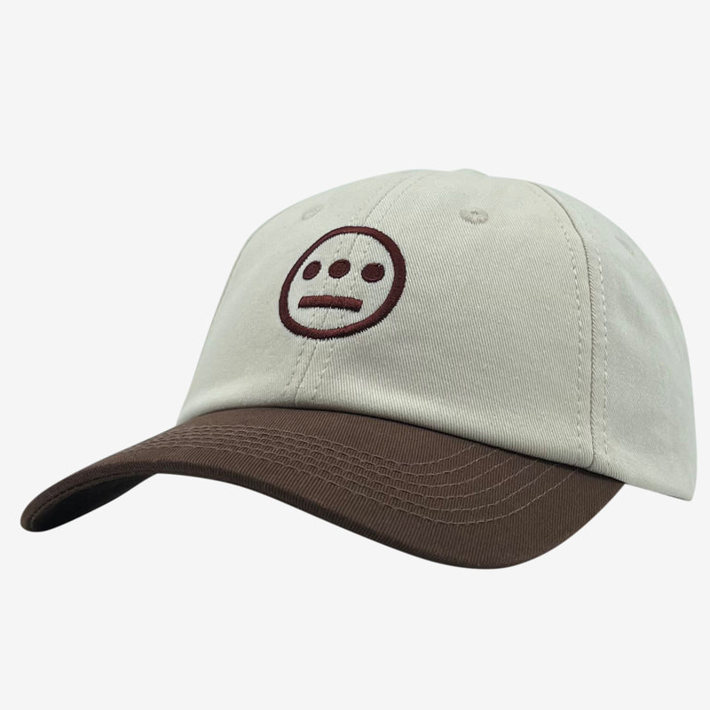 Side view of cream dad hat with brown embroidered Hiero hip-hop crew logo on a tan crown with contrasting brown visor.