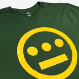 Close up of yellow Hieroglyphics Hip-Hop logo on a green t-shirt. 