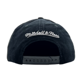 Back view of a black corduroy snapback cap with white embroidered Mitchell & Ness wordmark. 