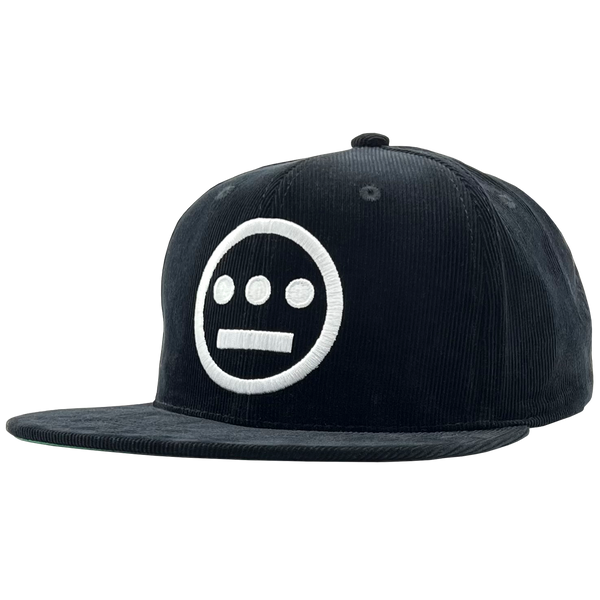 Side view of black Mitchell & Ness snapback corduroy cap with white embroidered Hiero Hip Hop crew logo.