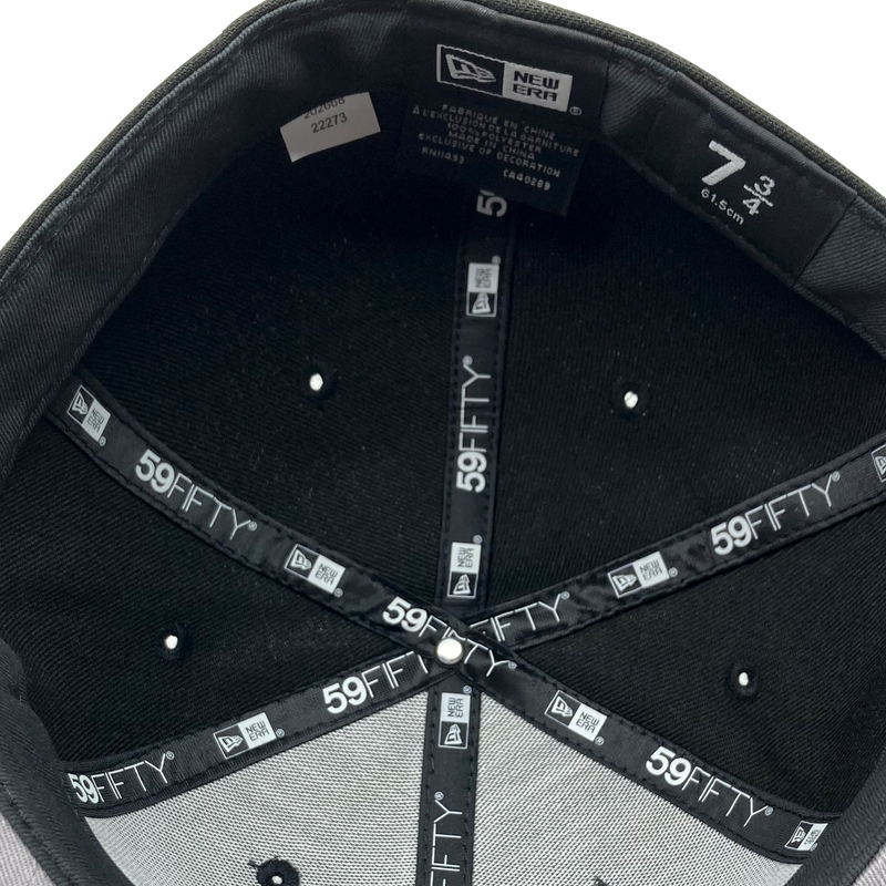 Detailed close-up of inside the crown of fitted New Era cap with black taping with 59FIFTY New Era wordmark on repeat. 
