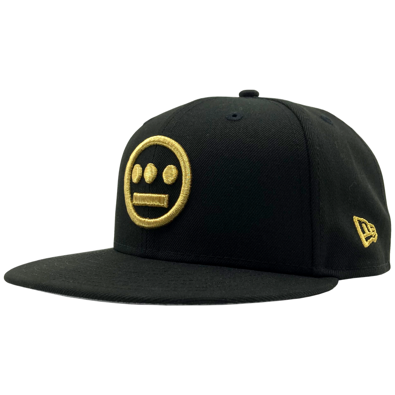 Side view of black New Era fitted cap with gold embroidered Hiero hip-hop logo on the crown.