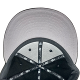 Grey undervisor and the inside the crown of a fitted New Era cap with black taping with 59FIFTY New Era wordmark on repeat. 