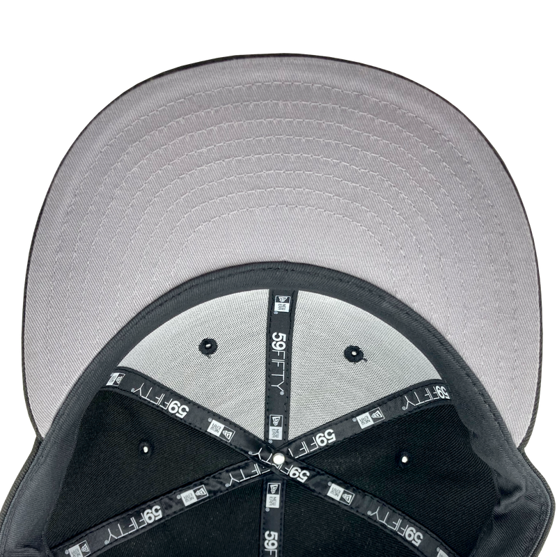Grey undervisor and the inside the crown of a fitted New Era cap with black taping with 59FIFTY New Era wordmark on repeat. 