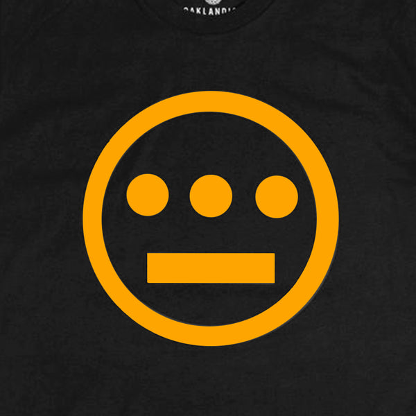 Detailed close-up of gold Hieroglyphics Hip-Hop logo on center chest of a black t-shirt.