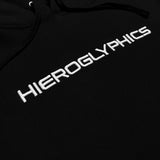 Close-up capitalized white embroidered “HIEROGLYPHICS” wordmark on the chest of a black hoodie.