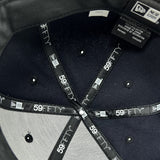 Detailed close-up of inside the crown of fitted New Era cap with black taping with 59FIFTY New Era wordmark on repeat. 