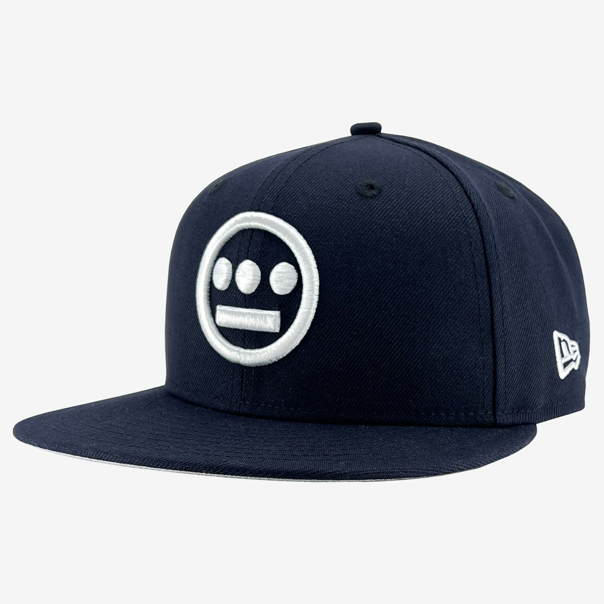 Side view of navy New Era cap with white embroidered Hieroglyphics hip-hop logo on the crown.