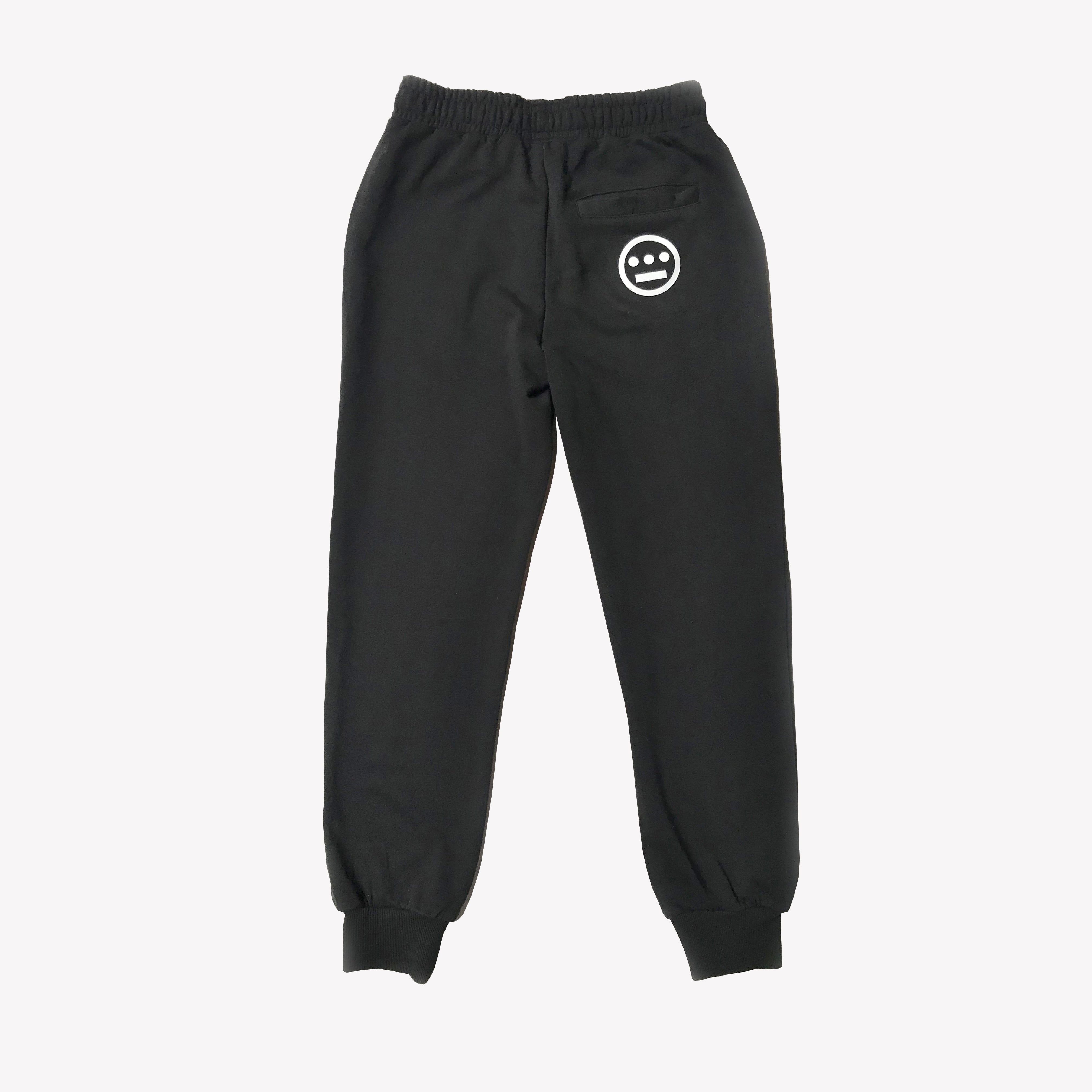 Back side of black joggers with round Hieroglyphics hip-hop logo on right wear side hip.