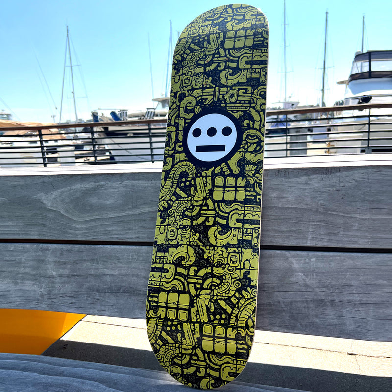Hieroglyphics skateboard deck with epitaph all over print on a wooden bench.