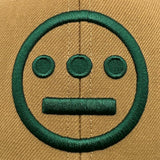 Detailed close-up of embroidered green Hiero hip hop logo on a brown Mitchell & Ness cap.