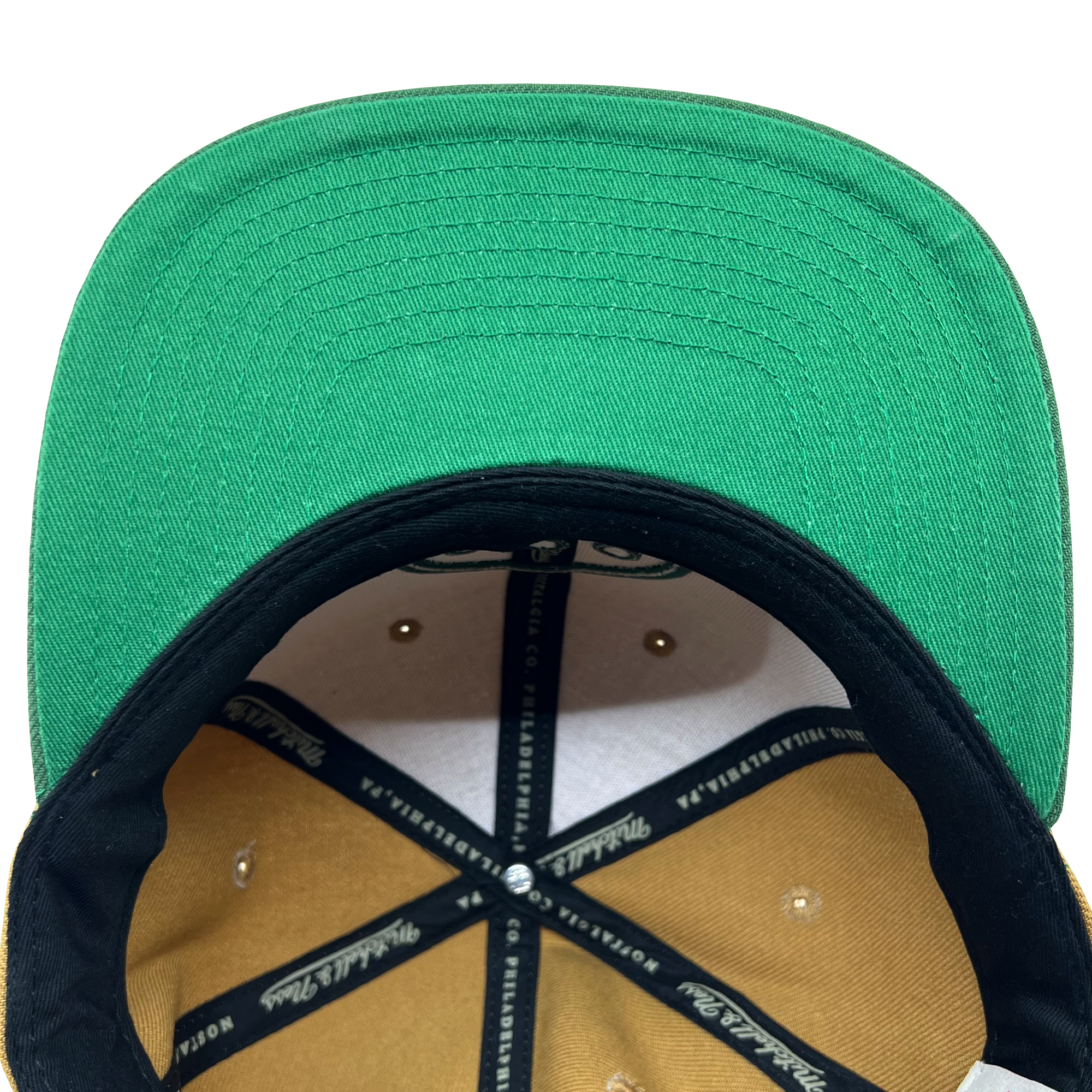 Detailed close-up of green undervisor and taping inside the crown of a Hiero hip hop X Mitchell & Ness cap.