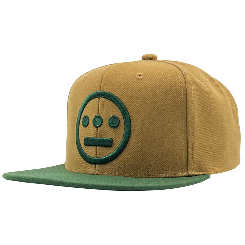Side angle of two-toned brown Mitchell & Ness snapback cap with green embroidered green Hiero Hip Hop crew logo & green visor.