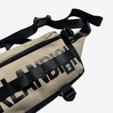 Close up left side sand nylon hip bag with waist belt, & small white Oaklandish tree logo.