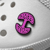 Pink and black Oaklandish tree logo shoe charm on a white croc clog.
