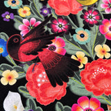 Close up of red bird in graphic designed by artist Jet Martinez on a black women’s t-shirt.