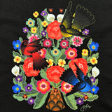 Close up of flower & bird design on a black t-shirt designed by artist Jet Martinez.
