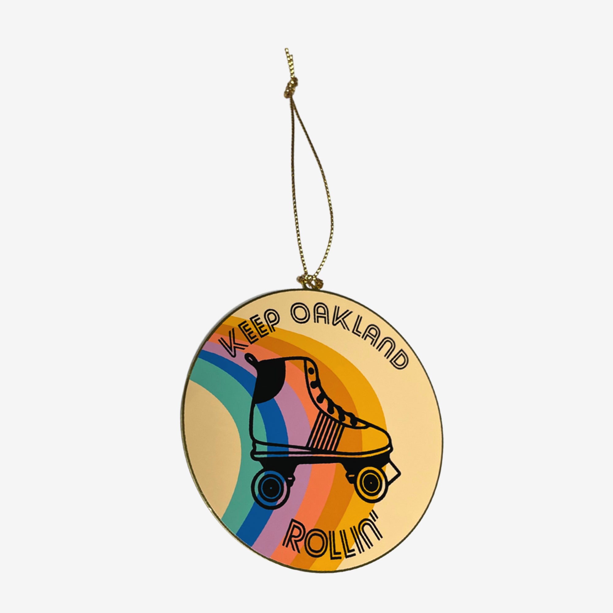 Keep Oakland Free holiday tree ornament with an illustration of a roller skate on a muted rainbow-colored circular disc.