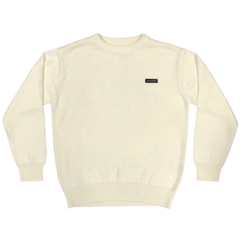 Heavy cotton white crew neck knit sweater with embroidered Oaklandish wordmark label on the front left chest.