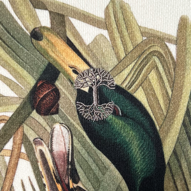 Detailed close up of embroidered Oaklandish tree logo on cream Mallard duck print hoodie.