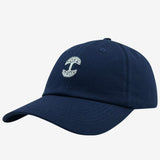 Side view of navy cotton dad hat with micro white embroidered Oaklandish tree logo.