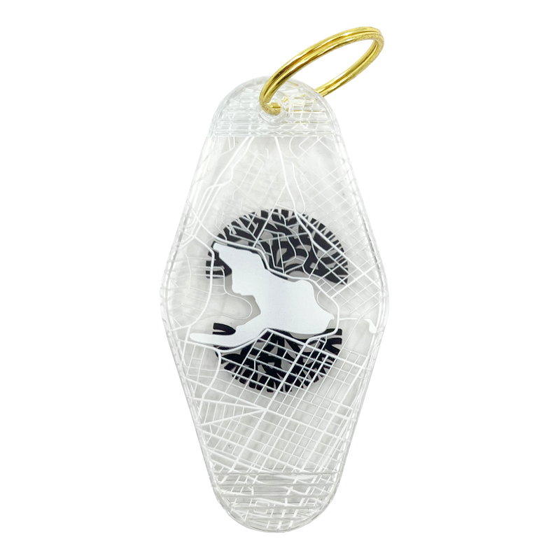 The backside of a translucent plastic motel keychain with an Oakland aerial view map with Lake Merrit in the center.