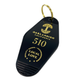 Black motel-style keychain with gold Oaklandish Logo and wordmark and 510 local love logo.