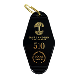 Black motel-style keychain with gold Oaklandish Logo and wordmark and 510 local love logo.