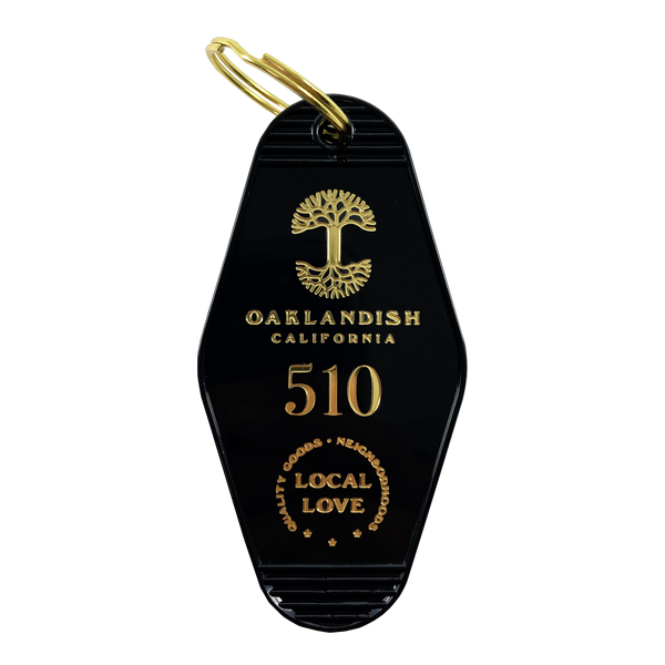 Black motel-style keychain with gold Oaklandish Logo and wordmark and 510 local love logo.