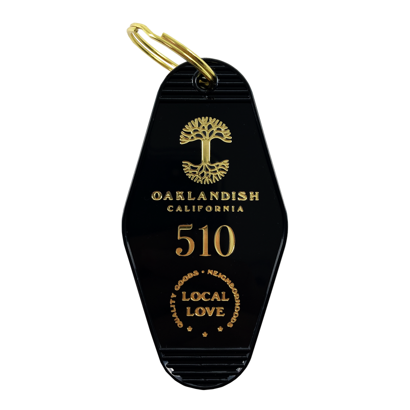 Black motel-style keychain with gold Oaklandish Logo and wordmark and 510 local love logo.