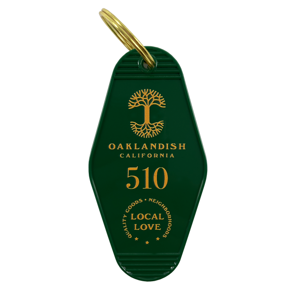Green motel-style keychain with gold Oaklandish Logo and wordmark and 510 local love logo.