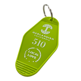 Detailed angle image of Lime green vintage motel-style keychain with gold Oaklandish Logo and wordmark and 510 local love logo.