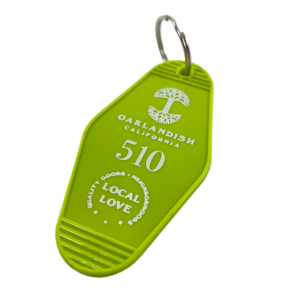 Detailed angle image of Lime green vintage motel-style keychain with gold Oaklandish Logo and wordmark and 510 local love logo.