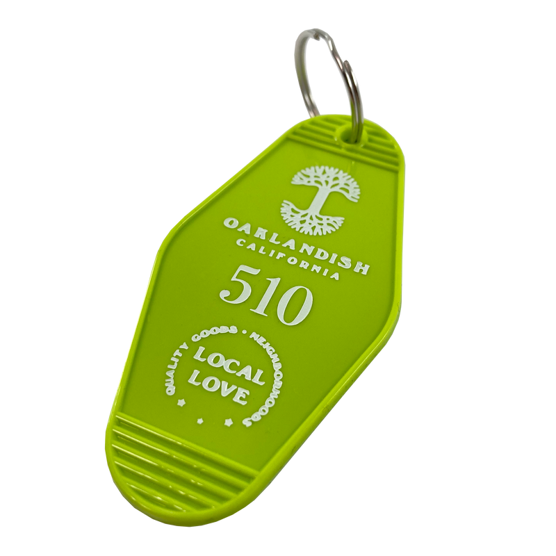 Detailed angle image of Lime green vintage motel-style keychain with gold Oaklandish Logo and wordmark and 510 local love logo.