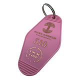 Detailed angle image of Pink vintage motel-style keychain with gold Oaklandish Logo and wordmark and 510 local love logo.