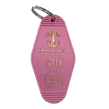 Pink vintage motel-style keychain with gold Oaklandish Logo and wordmark and 510 local love logo.