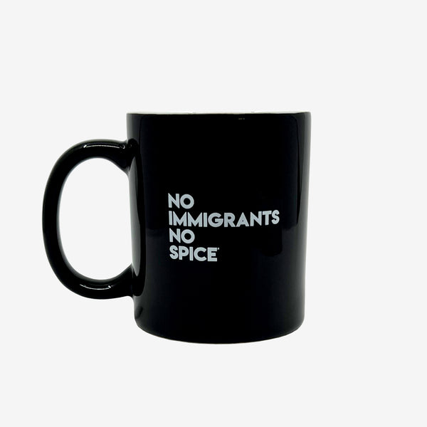 Glossy finish black ceramic coffee mug with white NO IMMIGRANTS NO SPICE wordmark.