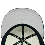 Inside view of the crown of New Era 59FIFTY fitted chrome hat with black New Era taping and grey under visor.