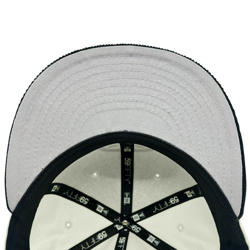 Inside view of the crown of New Era 59FIFTY fitted chrome hat with black New Era taping and grey under visor.