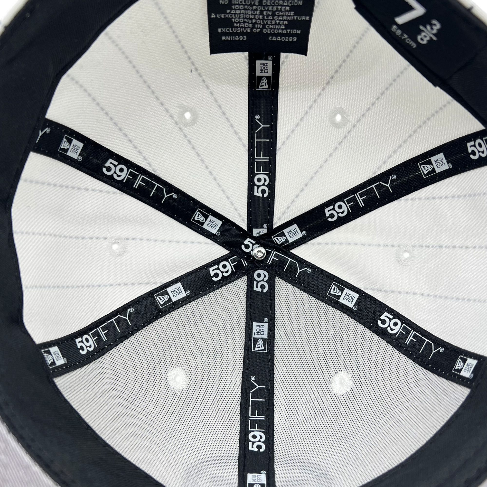 Interior view of a Hieroglyphics New Era Hiero Pinstripe 59FIFTY Fitted Cap, size 7 3/8, showcasing the black headband with the 59FIFTY logo repeatedly printed in white. The cap’s white interior fabric has stitched diamond patterns and a black circular band reinforcing the structure. Small white vents are visible.