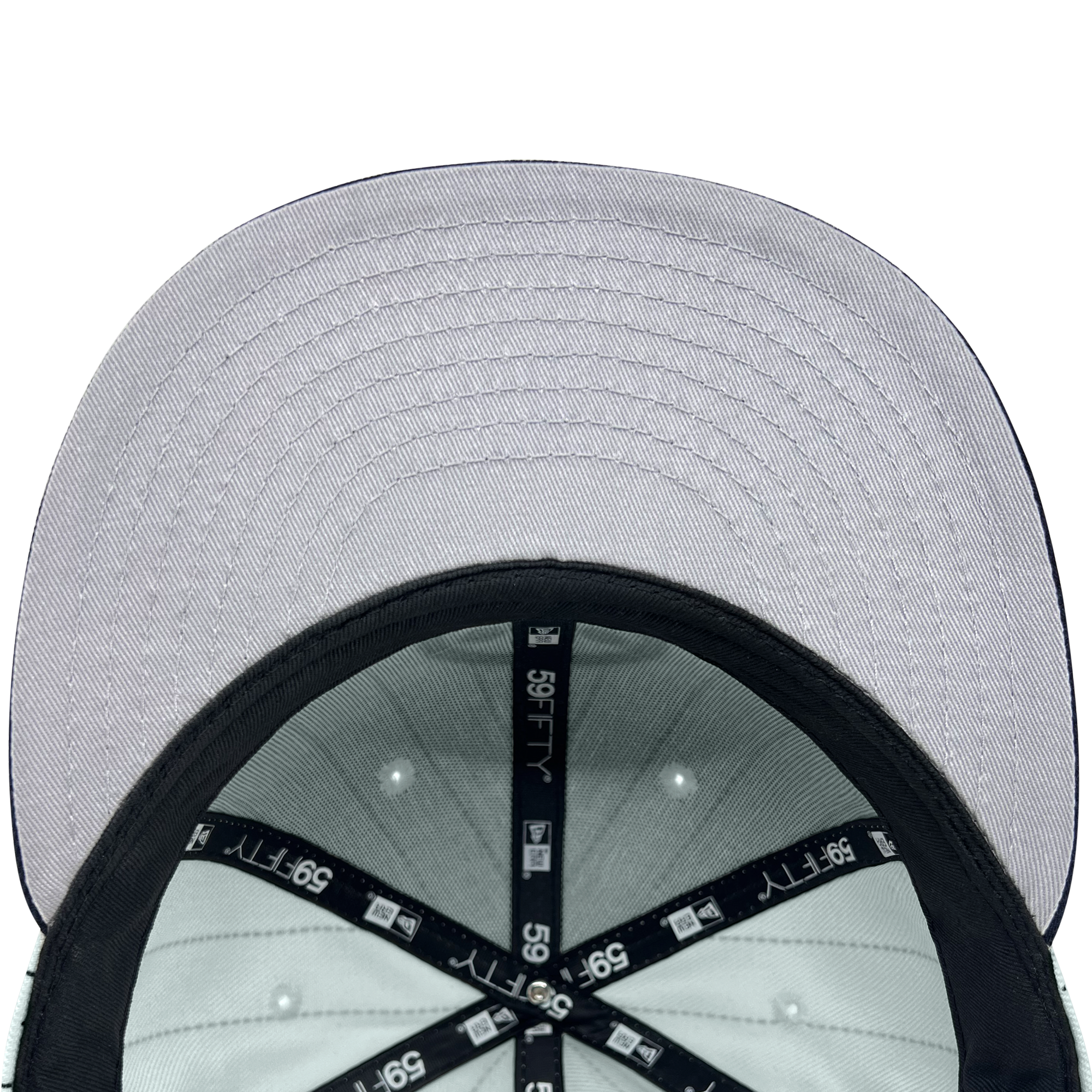 A close-up view of the underside of a light gray Hieroglyphics New Era Hiero Pinstripe 59FIFTY Fitted Cap. The cap features a black brim, and the internal structure includes black fabric bands with white "59FIFTY" text and branding. Several white stitching lines are visible on the brim, and small circular vents are located inside the cap.