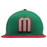 Front view of green New Era fitted cap with red and white Mexican baseball M patch and red bill.